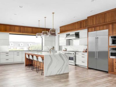 Beautiful Kitchen In New Luxury Home With Waterfall Quartz Island Pendant Lights And Hardwood Floors