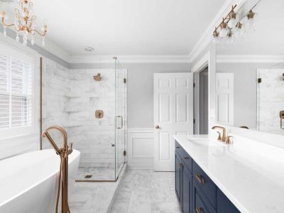 A Bathroom With A Blue Cabinet Bathtub And Tiled Shower