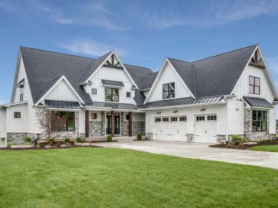 Large House With Steep Roof And Side Entry Three Car Garage